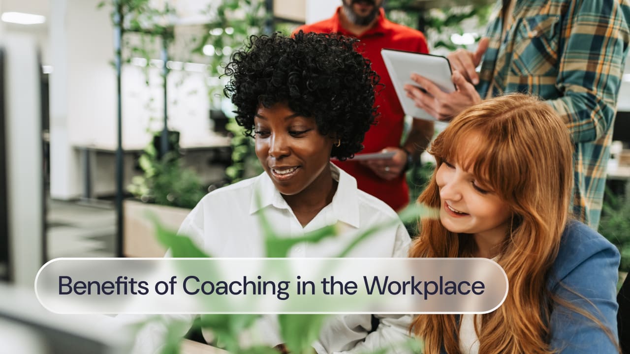Four people in the workplace, discussing something on a laptop screen. Text reads: benefits of coaching in the workplace