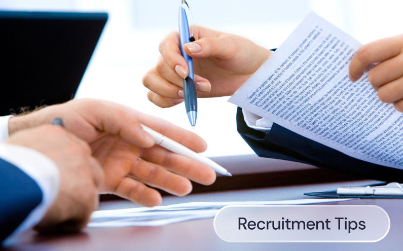 Two people signing papers on a desk with the graphic: Recruitment tips