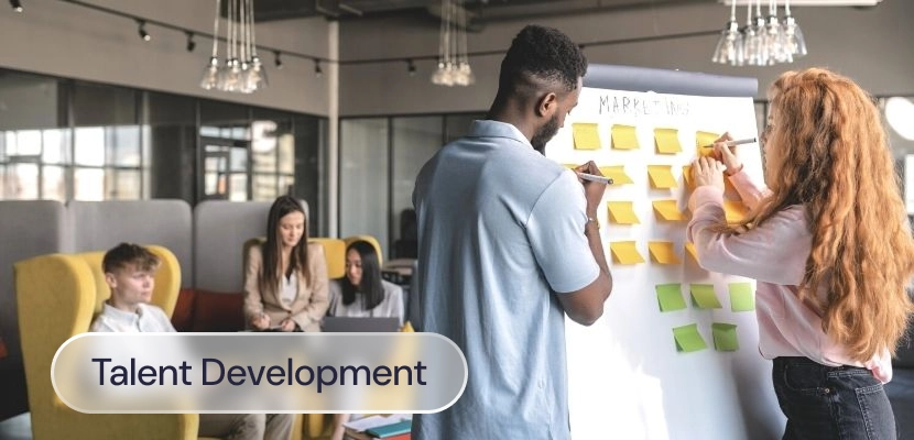 Two people using a flipchart during a talent development session