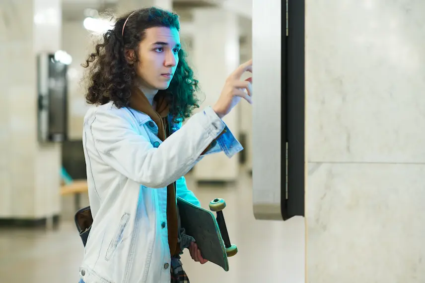 Man using biometric time clock to accurate clock in for work